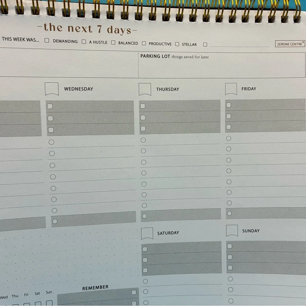 Zerone Productivity weekly planner featuring a gold spiral binding.